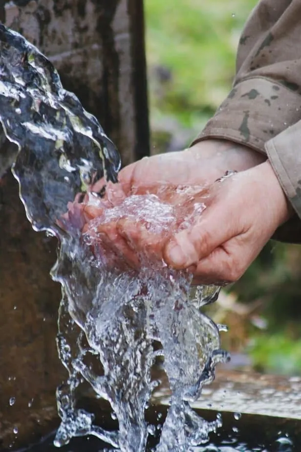 Clear water being poured into a glass vessel